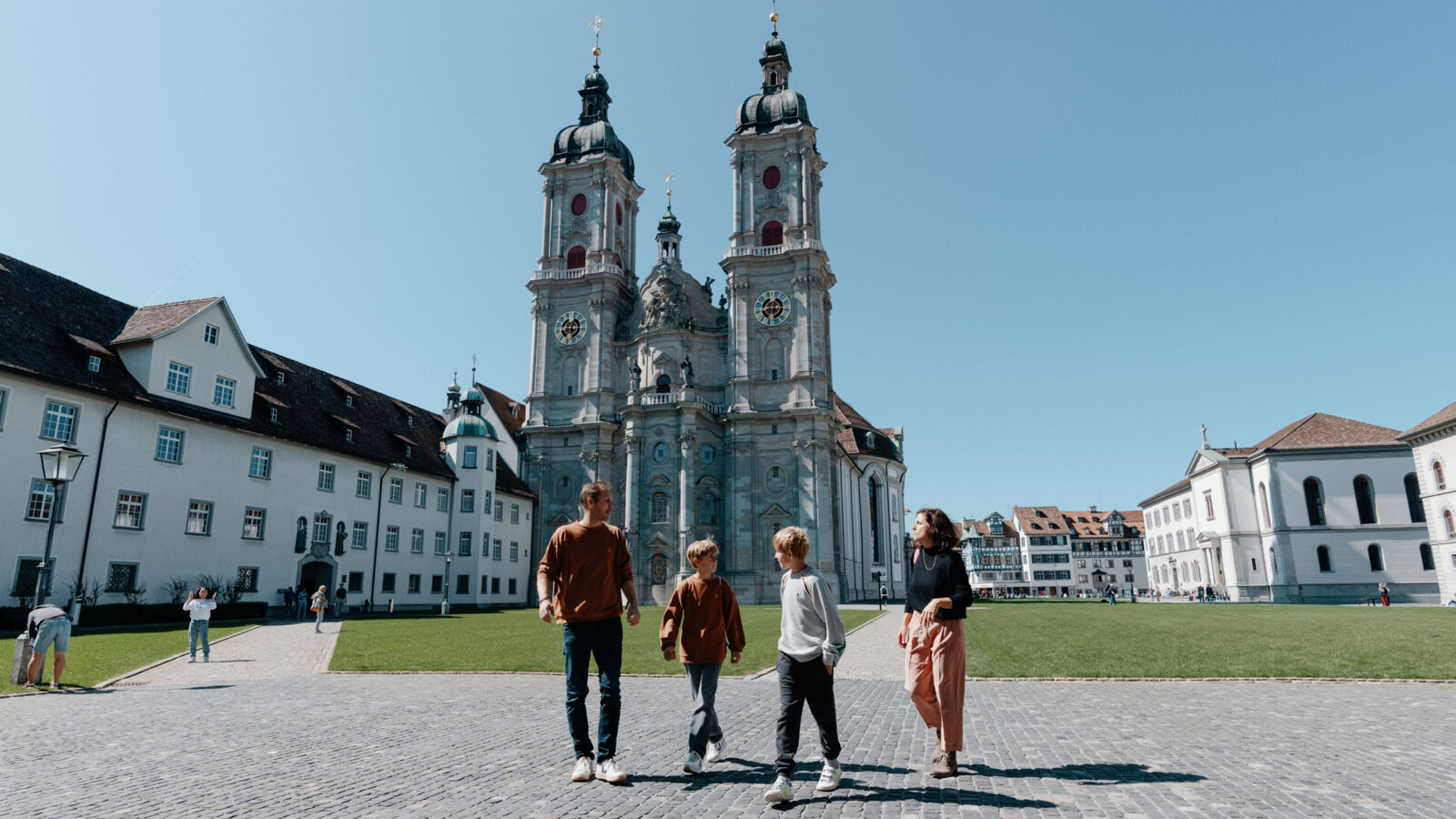 Family in the Abbey District of St.Gallen in front of the Cathedral